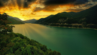Lake mountains sunset clouds boat - mountain under a cloudy sky free wallpaper