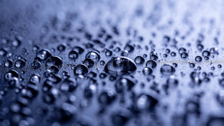 Water droplets macro blue bokeh - a surface of water free wallpaper