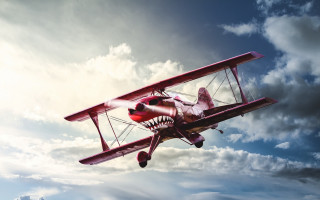 Red biplane shark mouth clouds - dieselpunk free wallpaper