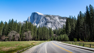 Mountain road fence trees nature - a mountain in the background and trees free wallpaper