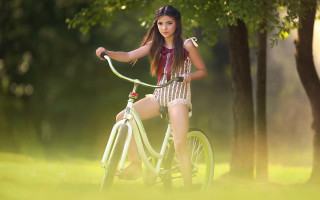 Woman bike park impressionist fashion - a green grass area free wallpaper