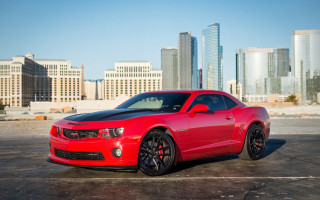 Red car cityscape skyscrapers 3d - a parking lot in front free wallpaper