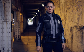 Woman police jacket tunnel cellphone - her hand and a cell phone free wallpaper