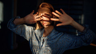 Woman hands up anamorphic flare - a face free wallpaper for desktop