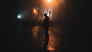 Man standing dark night streetlight - alone free wallpaper