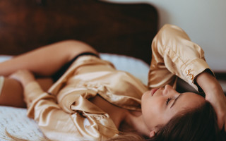 Woman lying bed blonde Asian - her hand and a cell phone free wallpaper