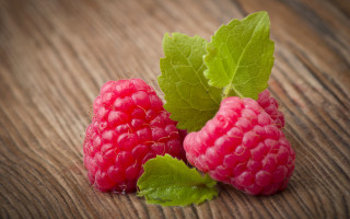 Raspberries leaves wooden surface pink - top of them free wallpaper