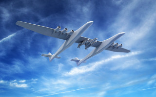 Futuristic airplanes blue sky clouds - the background and a plane in the foreground free wallpaper