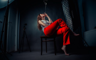 Woman red pants chair dark - elsa bleda free wallpaper