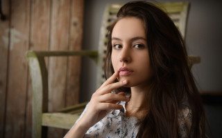 Woman sitting finger mouth portrait - her finger free wallpaper