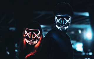 Two people neon masks dark - a neon light free wallpaper