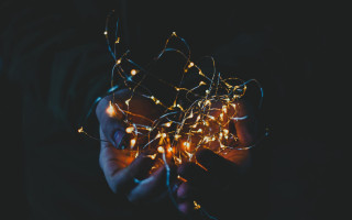 Glowing person holding lights dark - dynamic free wallpaper for desktop