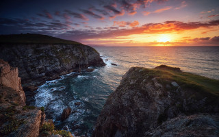 Sunset ocean rocky cliff boat - a sunset over the ocean free wallpaper