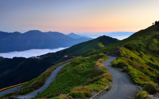 Mountain road clouds hill person - winding free wallpaper for desktop