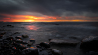 Sunset ocean rocks dark sky 3 - a dark sky in the background free wallpaper