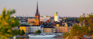 Boat city sunset tower skyscraper - a boat in the foreground free wallpaper for desktop