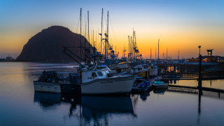 Boats harbor mountain sunset city - a mountain in the background and a body of water free wallpaper