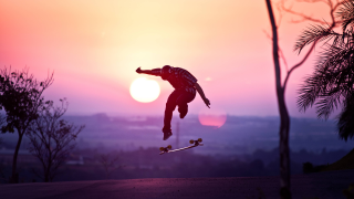 Skateboard jump sunset silhouette person - a skateboard in the air free wallpaper