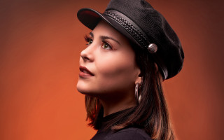Araceli gilbert portrait woman hat 2 - a red wall behind her free wallpaper