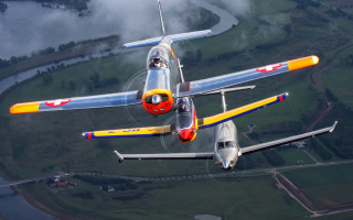 Airplanes sky river grass trees - a river in the background free wallpaper