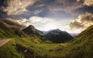 Mountain range road cloudy sky 3 - a scenic view of a mountain range free wallpaper