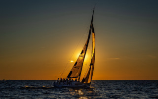 Sailboat sunset ocean reflection ceramic - a few person free wallpaper