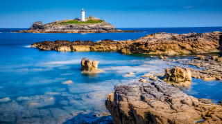 Lighthouse rocky shore blue water - blue water free wallpaper