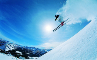 Skier mid air jump mountain - a skier free wallpaper