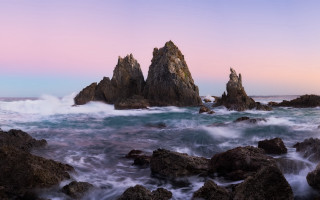 Rocky beach waves pink sky - a pink sky in the background free wallpaper