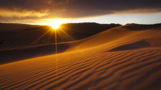 Desert sunset mountains clouds sand - over a desert landscape free wallpaper