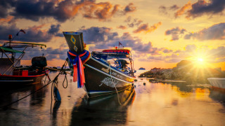 Docked boat sunset clouds horizon - the sun setting behind free wallpaper