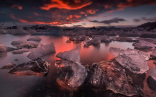 Sunset water rocks clouds cityscape - a sunset over a body of water free wallpaper