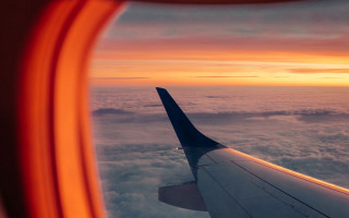 Airplane wing clouds sunset dawn - liminal space free wallpaper