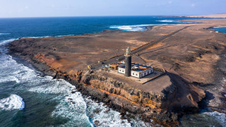 Lighthouse rocky island ocean waves 2 - aerial view free wallpaper for desktop