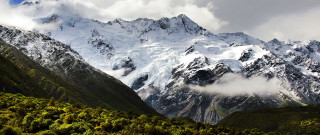Mountain range cloudy sky forest - a forest below free wallpaper