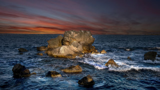 Rock formation ocean sunset island - a red sky above free wallpaper