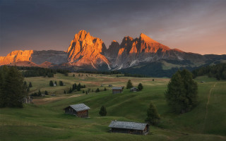 Mountain range cabins sunset clouds - the foreground and a sunset in the background free wallpaper for desktop
