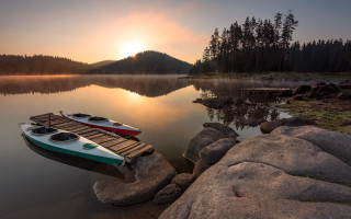 Boats lake mountains sunset foggy - a foggy sky free wallpaper