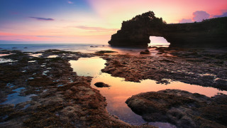 Rock formation hole sunset reflection - a rock formation free wallpaper
