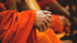 Couple holding hands orange robes - a line free wallpaper
