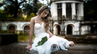 Woman white dress flower ledge - her hand and a building in the background free wallpaper