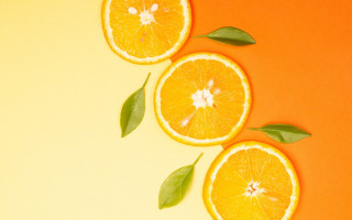 Three oranges leaves yellow background - a green leaf free wallpaper