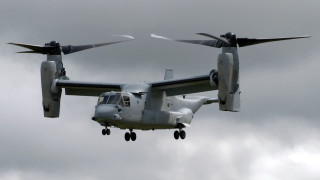 Large propeller plane flying cloudy 3 - the front of the plane free wallpaper