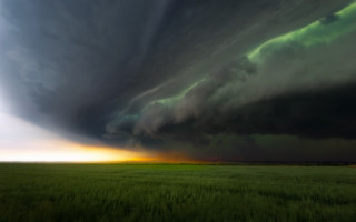 Storm cloud horizon grass mountain - a green field below free wallpaper