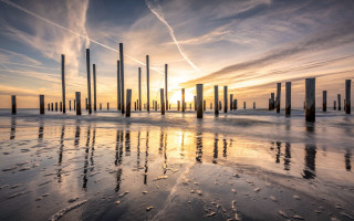 Beach poles sunset cityscape clouds - the sun setting free wallpaper