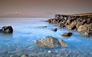 Pier rocky shore ocean blue - alexander johnston free wallpaper