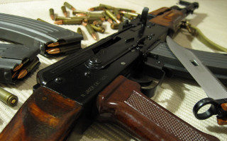 Gun table items surrounding laying - other item free wallpaper