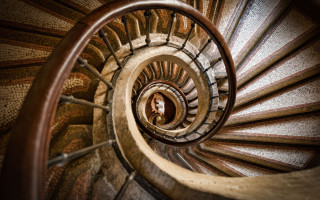 Spiral staircase person looking down - inside free wallpaper