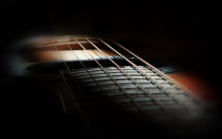 Guitar neck strings dark room 2 - a close up of a guitar neck free wallpaper