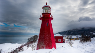 Red lighthouse snowy hill water - a snowy hill free wallpaper